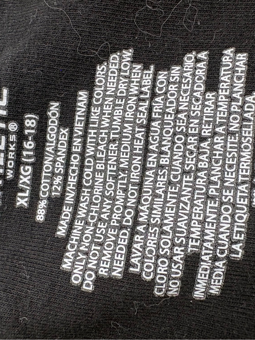 Black crop leggings xl with White Printed Care Label Text